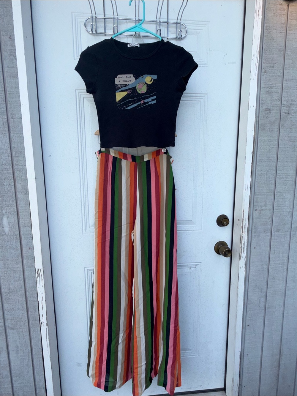 2-piece set.Reformation Multicolor Vertical Stripe Wide-Leg Pants and black top.